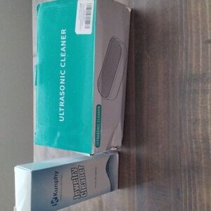 Ultrasonic cleaner with bottle of jewelry cleaner